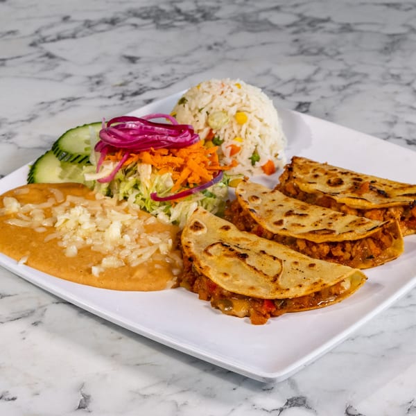 Mexican plate with three quesadillas, refried beans, rice, salad, and cucumber slices.